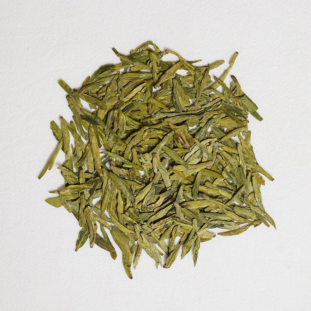 Longjing Dragon Well green tea leaves in glass teapot for premium cafe menu in Dubai